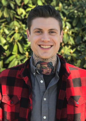 white male with brown hair in a checkered red flannel